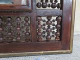 a close up of a wooden cabinet with a glass door