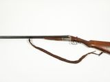 an old rifle with a wooden handle and a leather strap