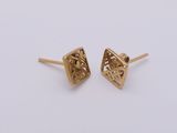 a pair of gold earrings with a diamond cut design