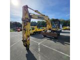 the back end of a yellow construction vehicle parked in a parking lot