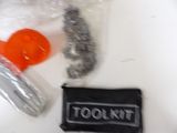a bag of tools and a plastic object on a table