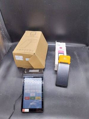 a cell phone sitting next to a box on the ground