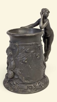 a statue of a woman sitting on top of a vase