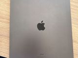 an apple ipad pro is sitting on top of a blue chair