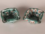 two small bowls that are sitting on a table