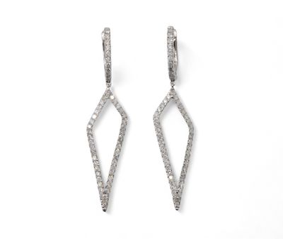 a pair of diamond earrings on a white background