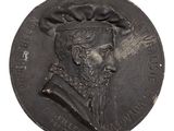 an old coin with a man wearing a hat on it