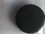 a black puck sitting on top of a white table