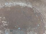 a large metal bowl that has some dirt on it
