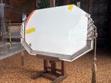 a large white object on a wooden stand in a room