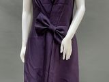 an image of a mannequin wearing a purple dress with a large bow