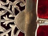 a silver belt with a decorative design on it