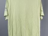 a light green t - shirt hanging on a hanger