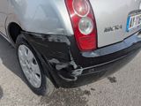 a car that has been damaged and is parked in a parking lot