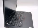 a black laptop with a red button on the keyboard