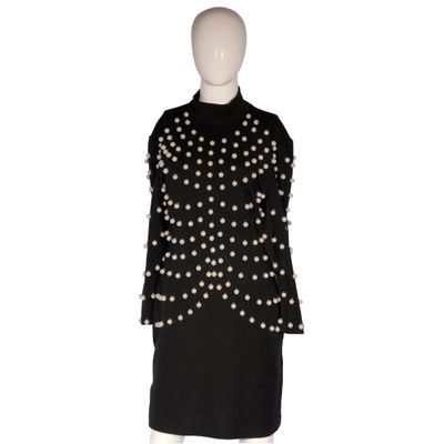a mannequin dress with pearls and pearls on the shoulders
