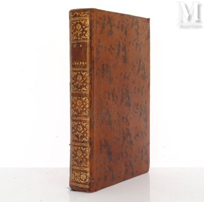 an old book sitting on top of a white table next to a white wall