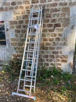 a ladder leaning against a brick wall next to a window