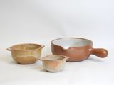 three bowls and a bowl on a white surface