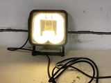 a light that is sitting on a table next to a wall