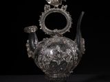 an antique silver teapot on a black background with a black background