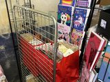 a metal cart with many items in it in a room