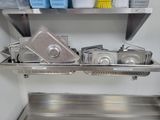 many pans and pans on a shelf in the kitchen
