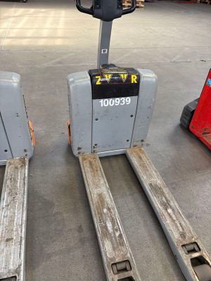 two forklifts that are sitting in a warehouse