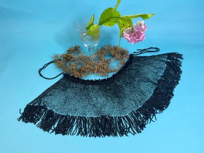 a black and gray scarf with a flower in it