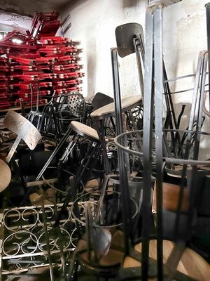 many chairs and stools in a room with a lot of them
