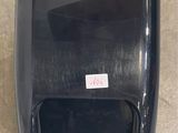 a black paper towel dispenser on the floor