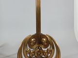 a gold table with a glass top on a white table