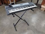 a keyboard that is sitting on a stand in a room