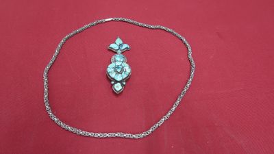 necklace and earring on a red cloth