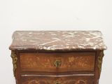 a small wooden chest of drawers with a marble top