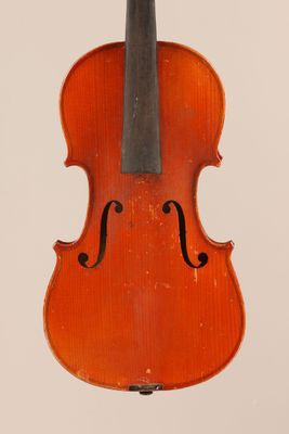 an old violin sitting on top of a white surface