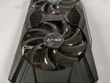 a close up of a video card on a table with a fan