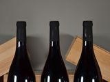 three bottles of wine sitting next to each other on a table