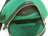 a green backpack with a zipper on the inside