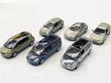 several toy cars are lined up in a row on a white surface