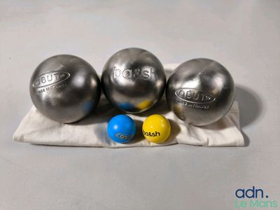 trois balles sont posées sur un tissu posé sur une table