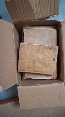 cardboard boxes are stacked on top of each other in a room