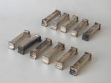 several pieces of metal are arranged on a white surface