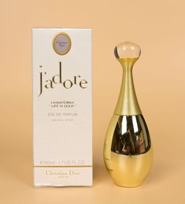 a close up of a bottle of perfume next to a box