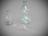 a glass vase and a glass bottle on a table