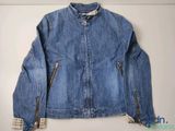 an image of a blue jean jacket hanging on a wall