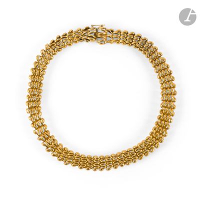 a gold chain bracelet with a clasp on a white background