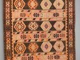 a brown and pink rug with a design on it