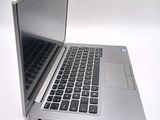a silver laptop computer sitting on top of a white table