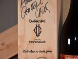 a bottle of wine sitting next to a wooden box